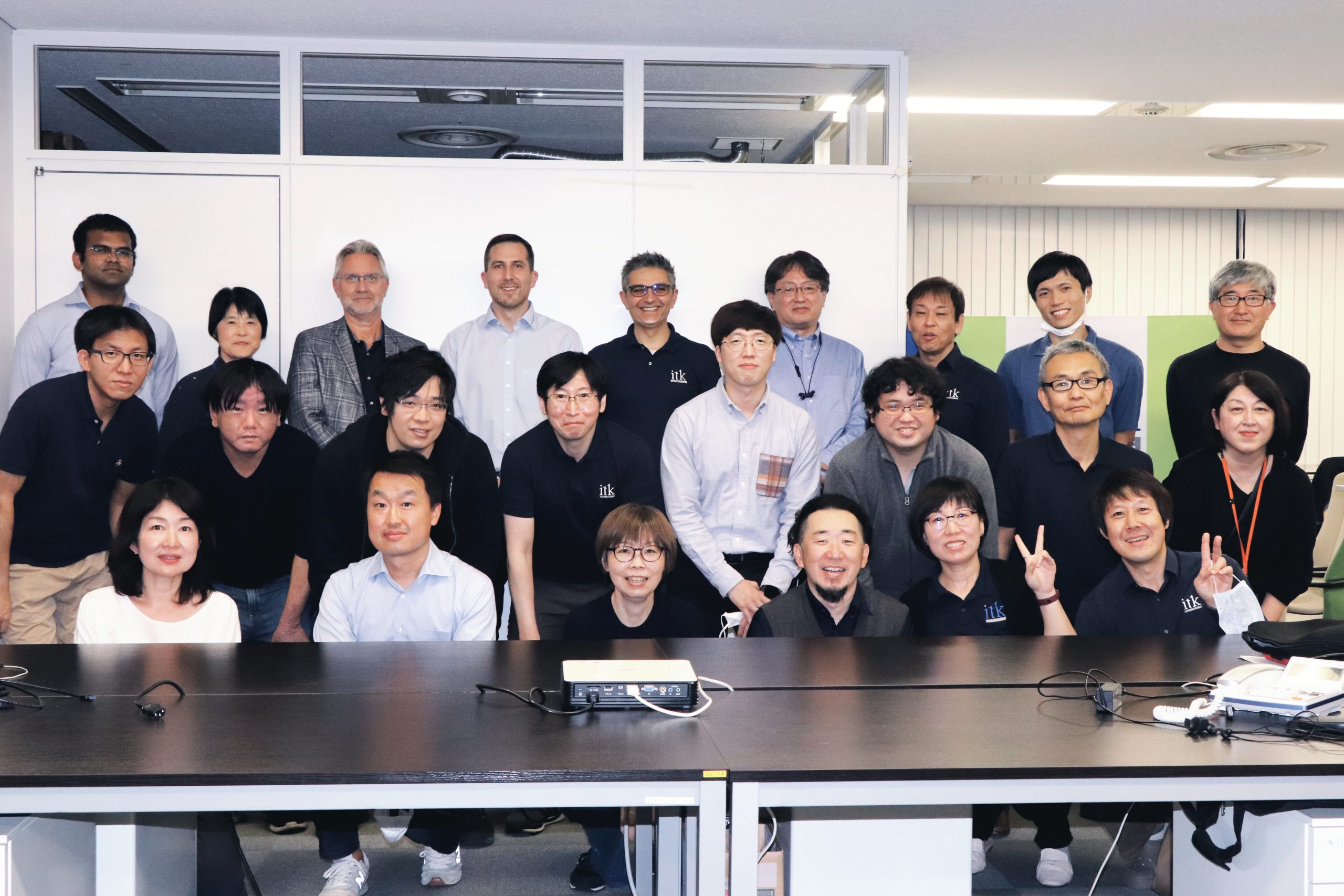 a large group of employees behind a conference table