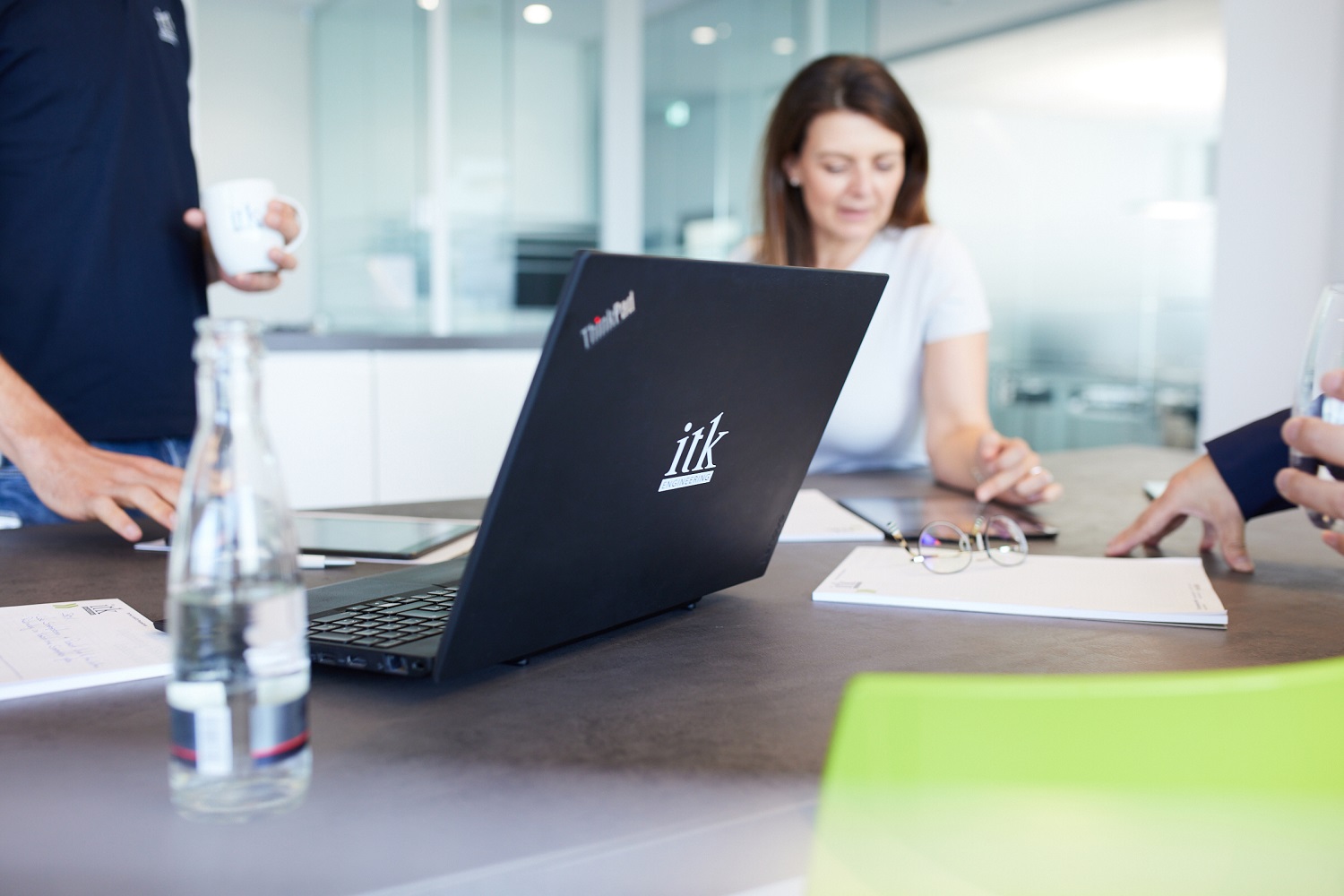 ITK laptop on a table with ITK employee in the background