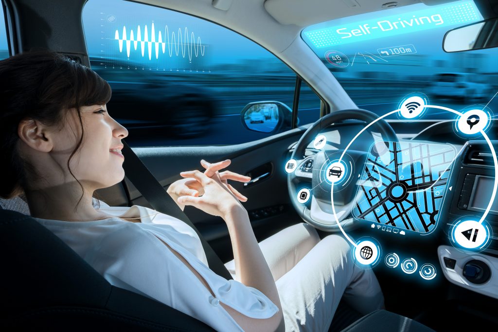 woman siting in the drivers’ seat and looking at a head-up display